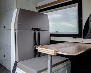 Front of the interior of a camper van with the table set up