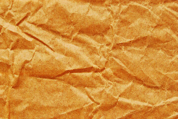Orange color wrinkled paper texture, a sheet of glossy orange recycled wrinkled paper texture as background