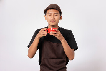 Handsome barista asian man wearing brown apron and black t-shirt isolated over white background....