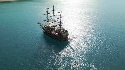 Kemer, Turkey - 13 October 2022: Aerial view of Pirate ship crew swimming in the sea