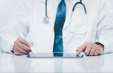 professional doctor man wearing a uniform using a device tablet of hospital. doctor touchscreen tablet for health care and treatment remote from internet online patient. doctor use technology concept