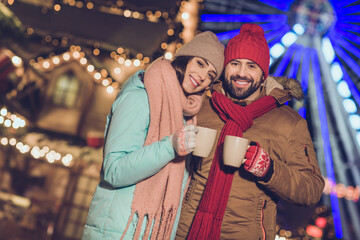 Fototapeta premium Photo of pretty shiny girlfriend boyfriend embracing enjoying hot beverage mugs outdoors urban city market