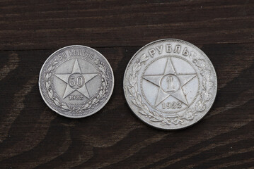 Old Russian silver ruble and a half on wooden table