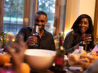 Man and woman drinking red wine at Thanksgiving dinner