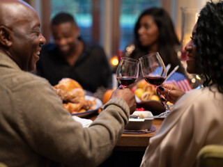 Family drinking red wine at Thanksgiving dinner