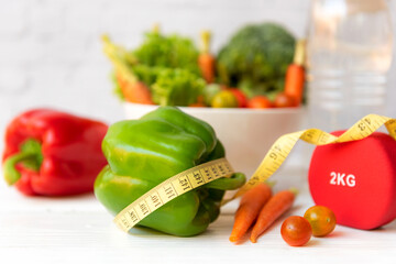 Diet Healthy food and lifestyle health concept. Sport exercise equipment workoutÂ andÂ gym background with nutrition detox salad for fitness style. Health care Concept