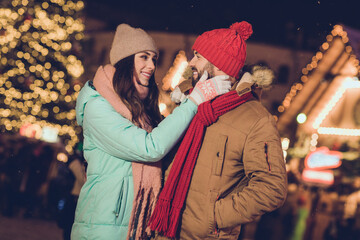 Photo of cute millennial lovers hug look wear cap jacket scarf gloves near tree outside outdoor