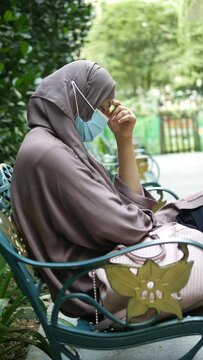  thoughtful muslim woman with flu mask looking away 