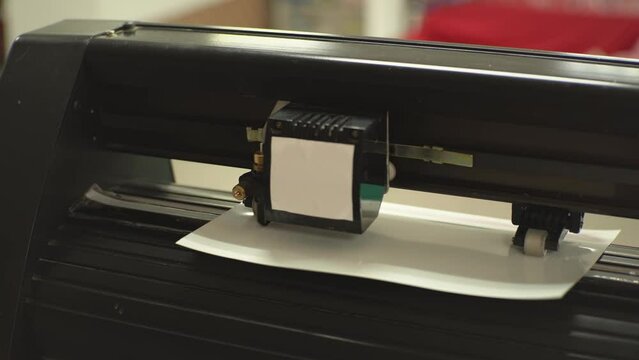 Cutting plotter with white paper. High-quality shooting in 4k format