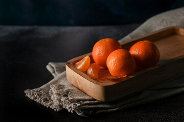 Bright orange clementine tangerines lie on the table 

