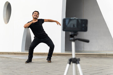 Energetic man recording video of dance