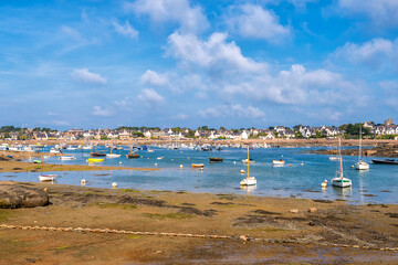 Fototapeta na wymiar Scenic view of small harbor in Brittany, France at low sea tide against dramatic sky