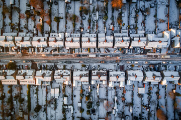 Snow Covered Houses and Rooftops in the Winter along a Quiet Road
