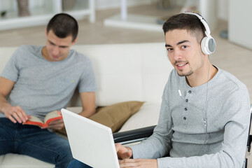 two young men studying at home