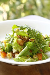 Caesar salad on a wooden table on a sunny day