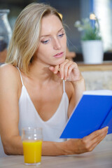 beautiful woman ordering from menu in restaurant