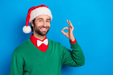 Photo of cheerful person arm fingers demonstrate okey symbol toothy smile isolated on blue color background