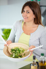 woman with healthy vegetable salad at home