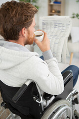 happy disable man reading the news