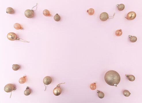 Christmas Gold Baubles Frame On Pink Color Background, Top View.