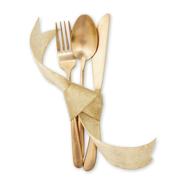 Gold cutlery and ribbon decoration isolated on white. Christmas table setting top view.