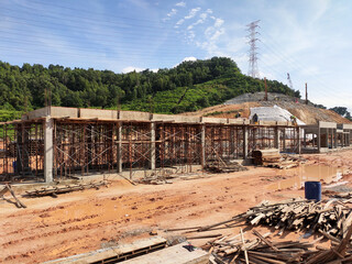 Fototapeta premium MELAKA, MALAYSIA - MARCH 4, 2021: The building structure is made of reinforced concrete still under construction. This reinforced concrete mold is made of timber and plywood formwork.