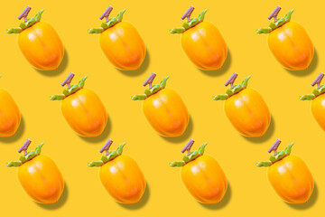 Persimmon fruit on yellow background.