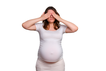 Pregnant woman covers her eyes with her hands, studio shot on white background