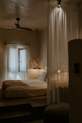 Modern interior design boutique hotel room in Rhodes, Greece. Bedroom, lounge room, lime wash walls, linen curtains