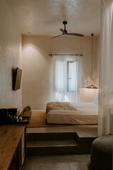 Modern interior design boutique hotel room in Rhodes, Greece. Bedroom, lounge room, lime wash walls, linen curtains