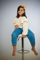 Fun cheerful happy little kid girl in white shirt and blue jeans posing gesturing hands isolated on white background children studio portrait. People childhood lifestyle concept. 