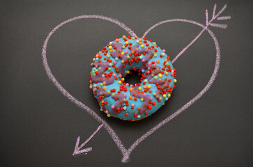 glazed donut and heart drawn in chalk on a blackboard, romantic image