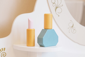 Children's toys for child made of wood, imitating cosmetic accessories. Perfume bottle and lipstick. Logo mocap. Eco-friendly toys for little girls.