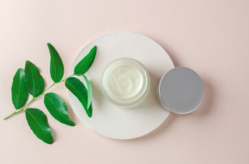 The concept of natural cosmetics for spa treatments. Moisturizing cream white packaging mockup. Open jar of body moisturizer