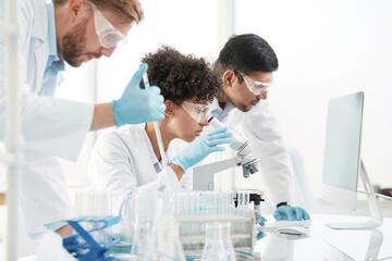 scientists are conducting research in a medical laboratory . © yurolaitsalbert