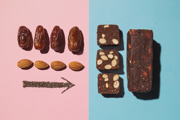 Protein date fruit candy bars fitness with nuts and fruit almond and chia poppy seeds top view on blue pink background with copy space and place for text