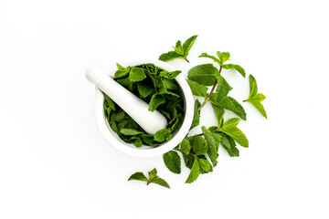 White mortar with fresh green mint leaves. Aroma herbs background