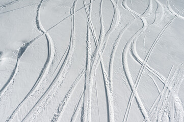 deep trace from ski and snowboard on snow winter mountain slope, freeride