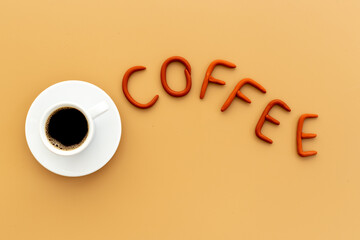 White cup of hot espresso with rubber letters coffee
