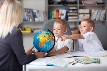 Teacher and children with globe, geography interesting learning.