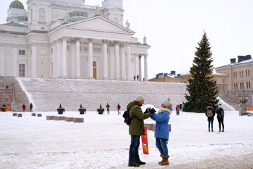 view of Helsinki Cathedral and Statue Of Emperor Alexander II Of Russia on, people walking along...