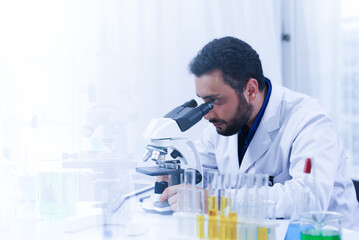 male scientist Laboratory specialist working with a microscope, liquid