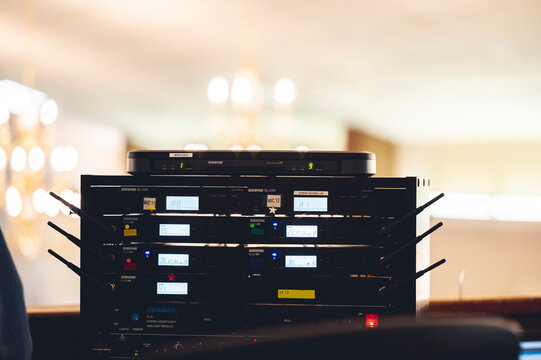 Audio receivers equipment sitting on a shelf at an event