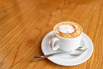 Hot coffee cappuccino latte art top view on wooden table