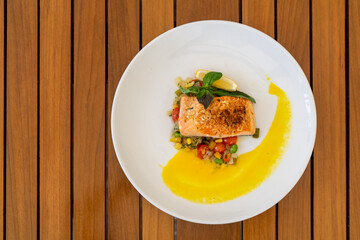 Salmon stake with lemon vegetable and sauce, top view