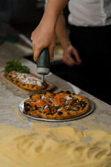 Professional kitchen - chef preparing delicious pizza, pizza cooking process