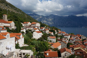 Naklejka na ściany i meble Houses on the steep mountain slopes of the Bay of Kotor. Perast, Montenegro.