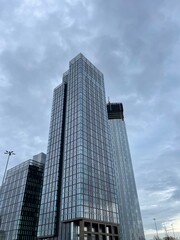 Obraz premium Looking up at modern buildings with a sky background. Taken in Manchester City centre. 