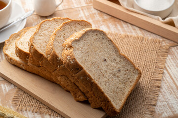 Sliced whole wheat bread on wooden cutting board,healthy food concept