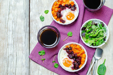 Beet Sweet potato baked eggs on a wood background